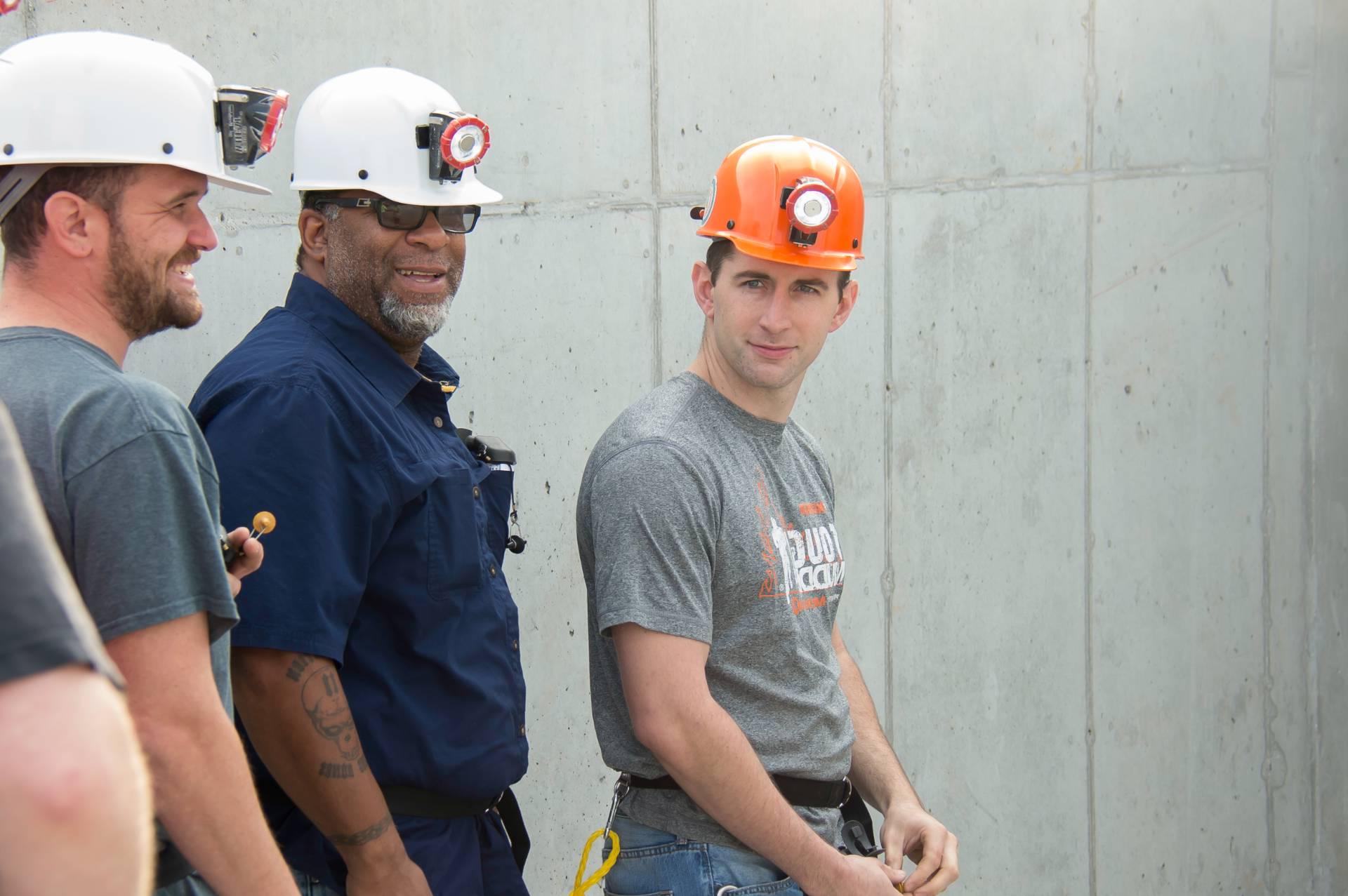 Three men wearing hard hats